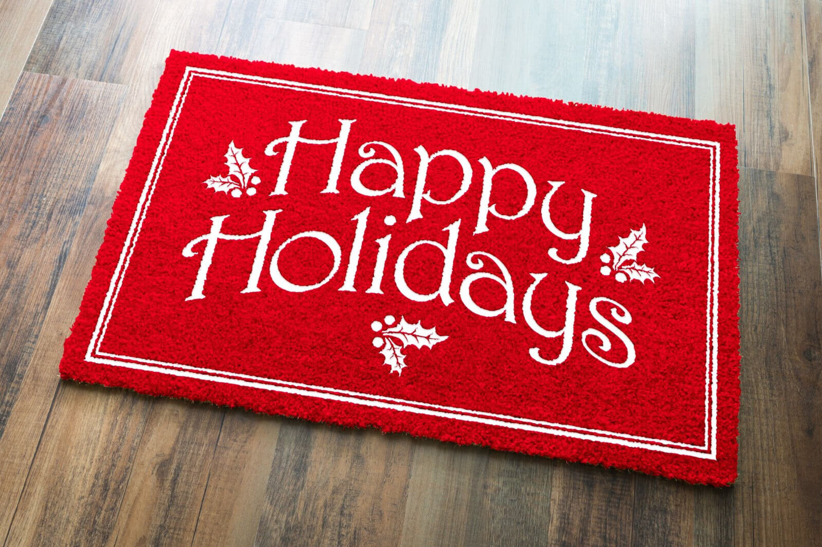 A red welcome mat saying "Happy Holidays."