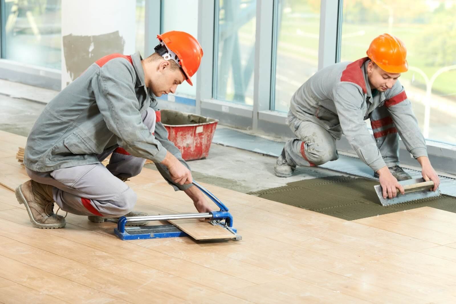 Workers installing hardwood flooring.