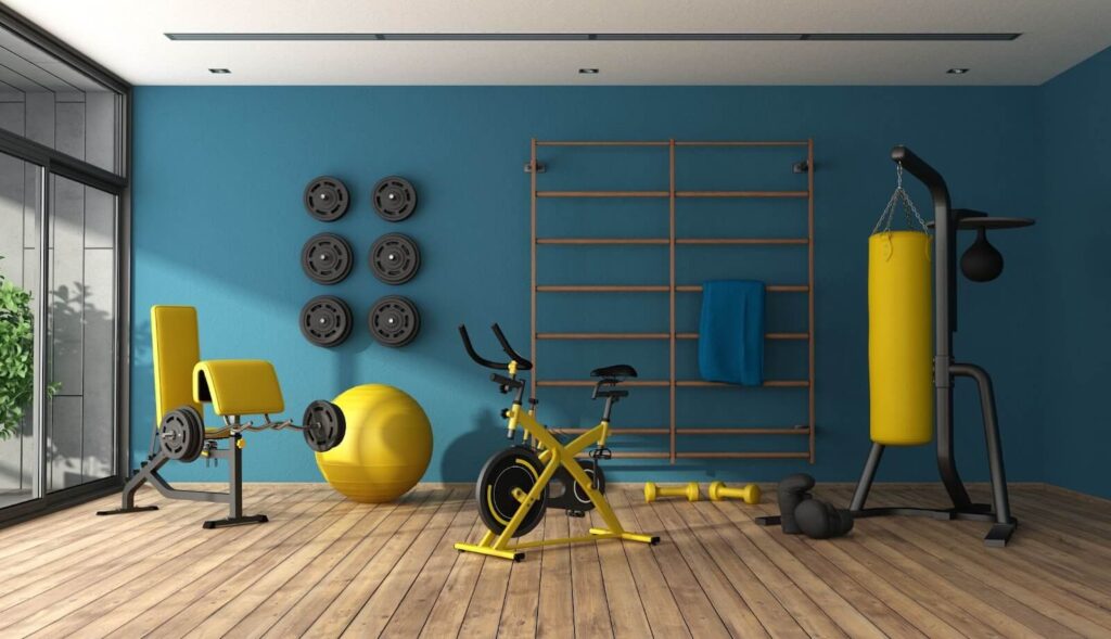 A home gym filled with yellow and grey equipment.